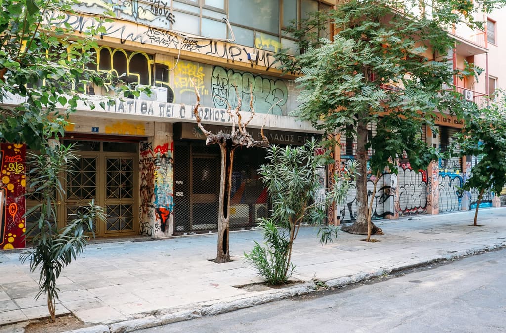 A street covered in graffiti and street art in Exarchia, Athens